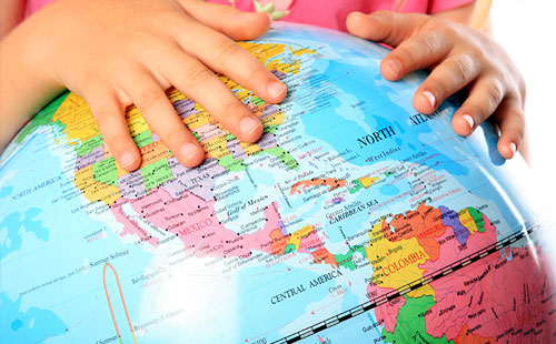 Child studying a globe