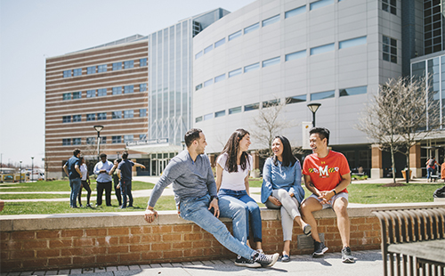 Students sitting outdoors on campus.