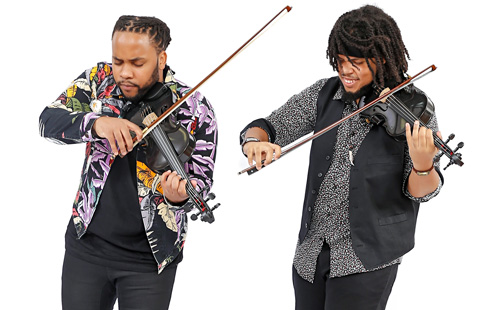 Image of two men playing black violins