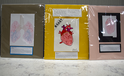 three different pieces of art created by students at a summer camp.