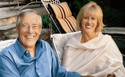 Bill and Pamela Hard sitting together outside and smiling