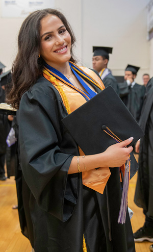 Madeline “MADDY” Hishmeh sitting at a desk smiling