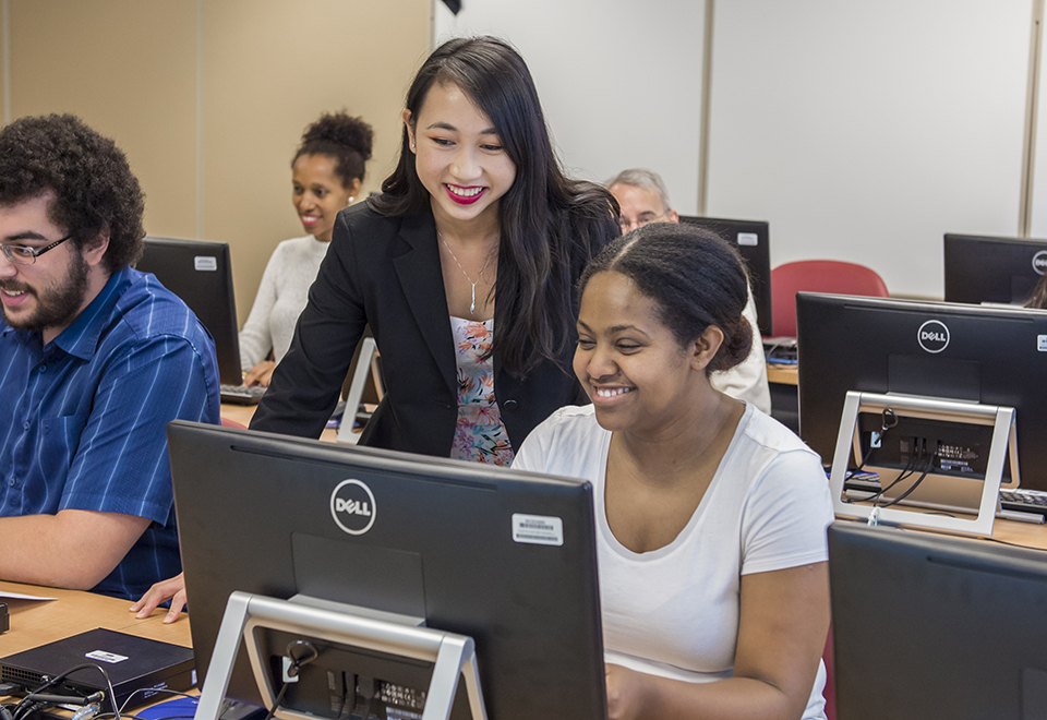 students looking at laptop