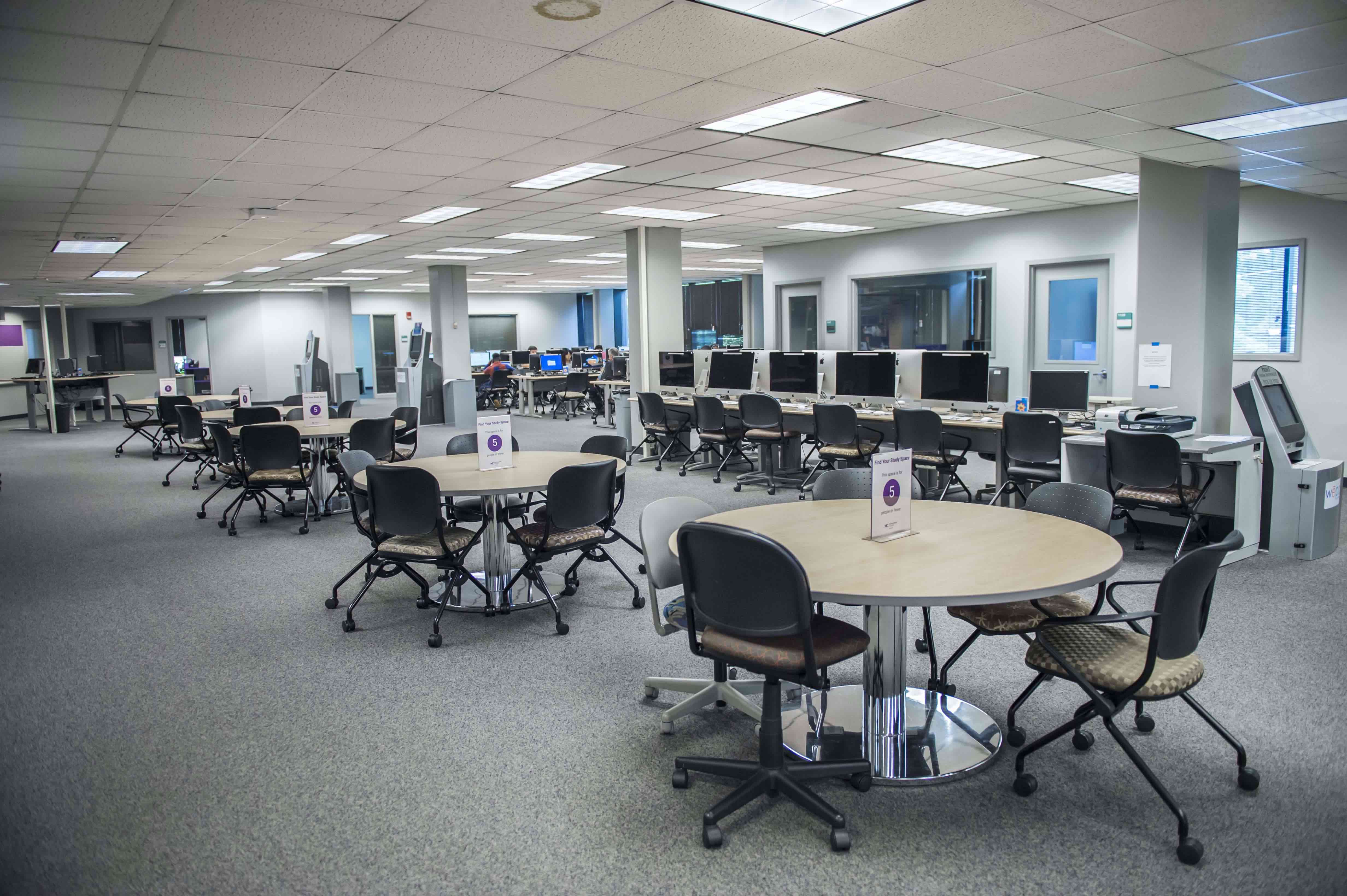 study spaces, including tables, chairs, and computers, at the rockville campus library
