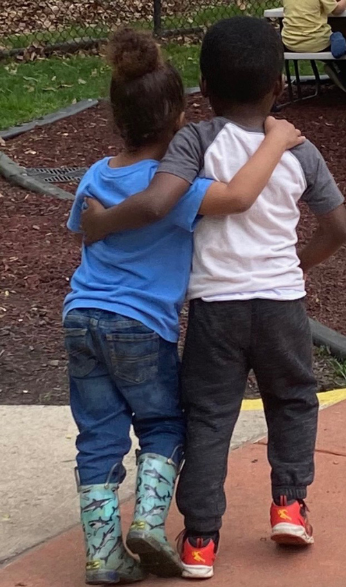 two children with arms around each other's shoulders