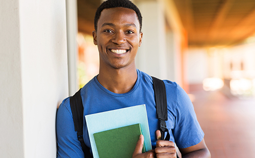 Happy teen working on his GED